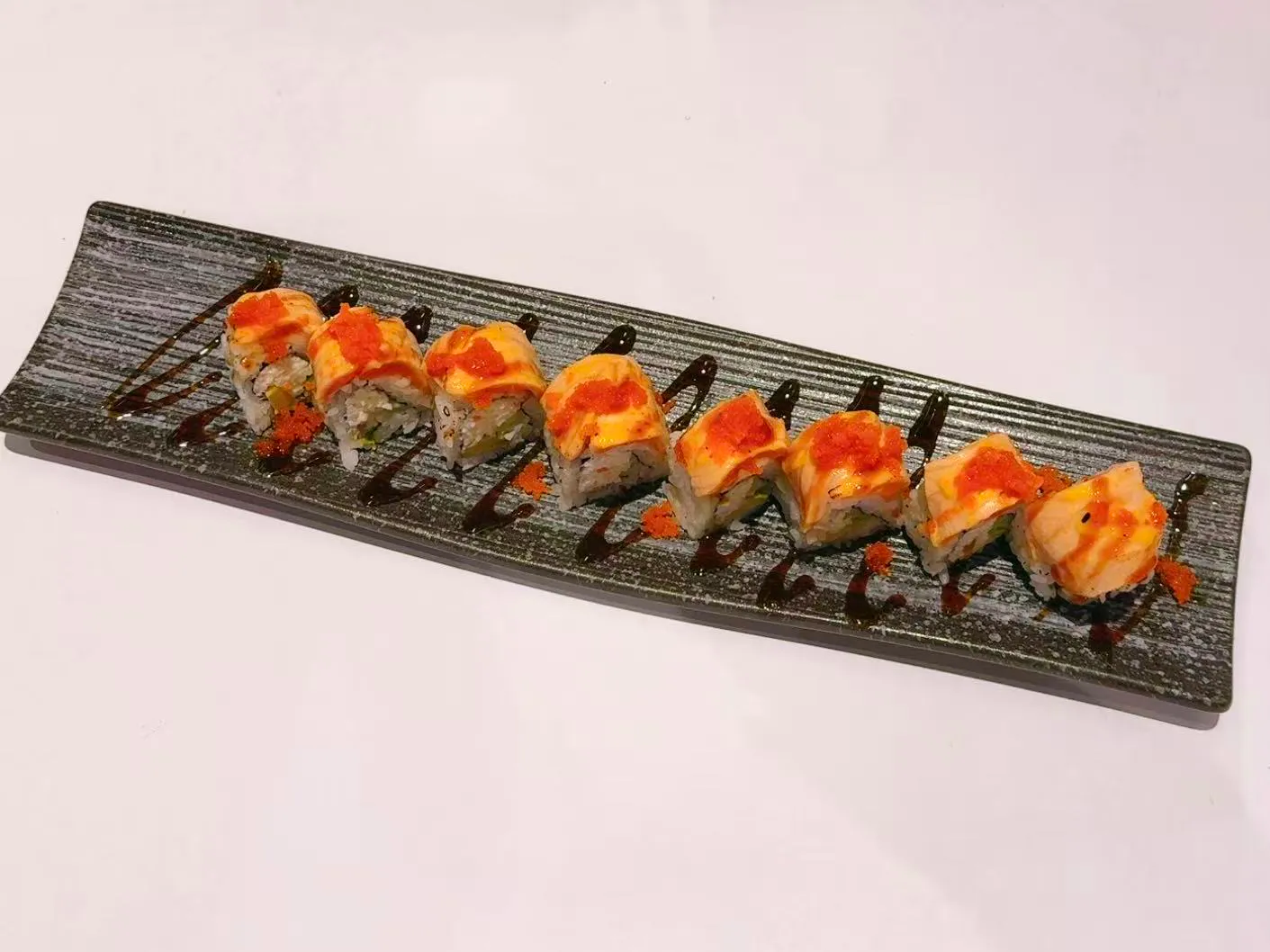 Baked sushi roll with creamy sauce and tobiko at Mushi Sushi & Ramen, a Japanese Restaurant in Happy Valley