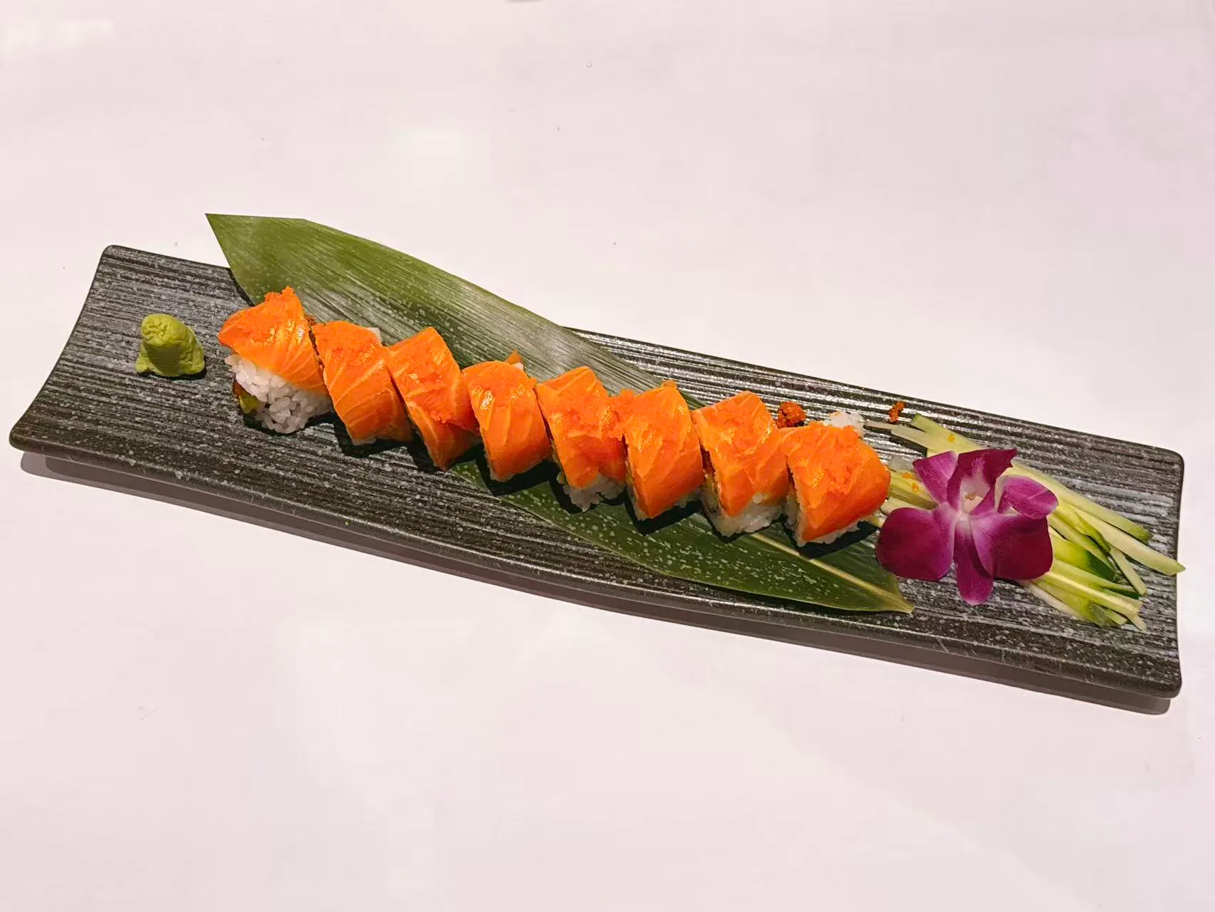 Fresh salmon sushi roll with garnishes and wasabi at Mushi Sushi & Ramen, a Japanese Restaurant in Happy Valley