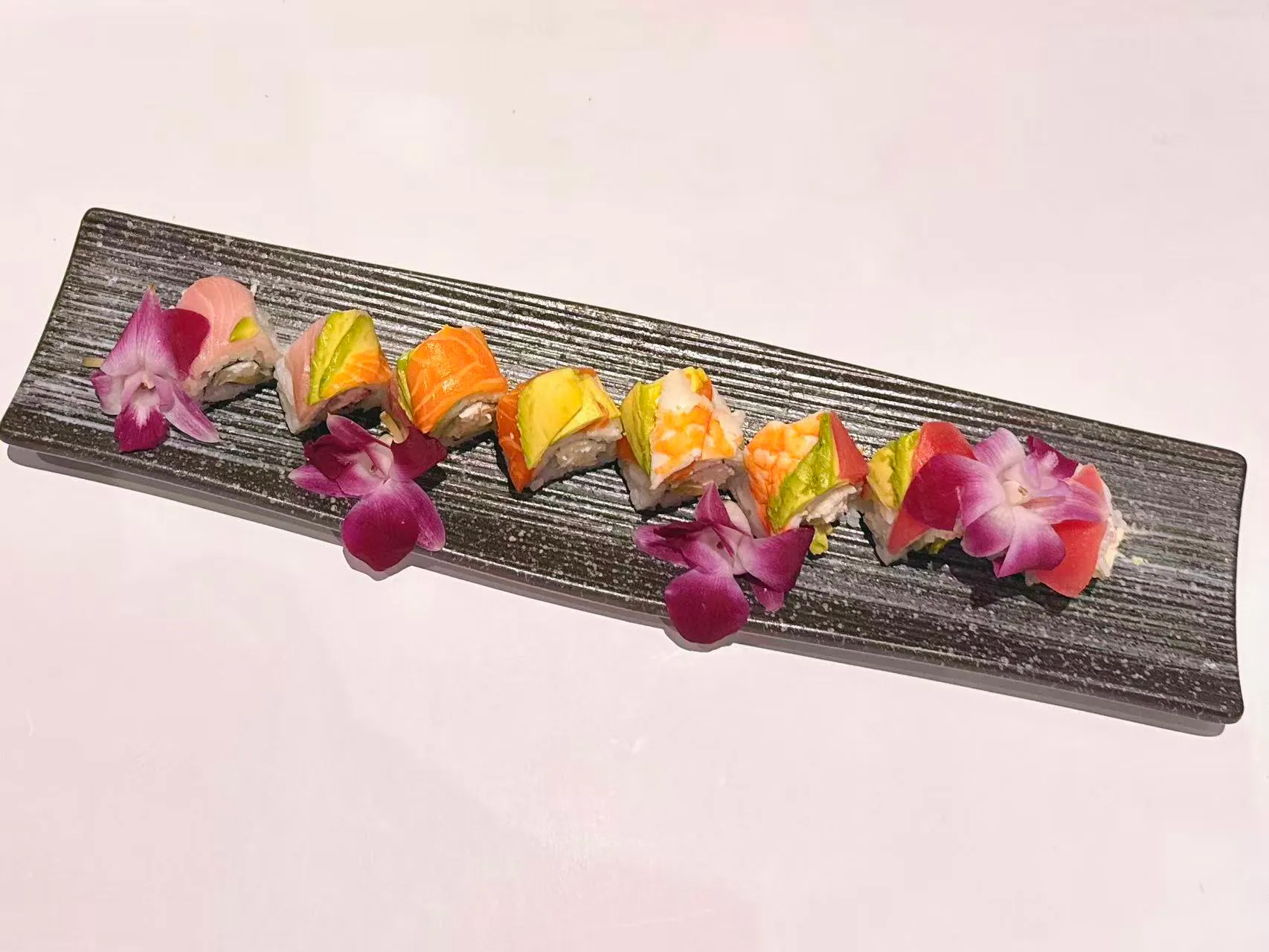Rainbow sushi roll with assorted fish and avocado at Mushi Sushi & Ramen, a Japanese Restaurant in Happy Valley